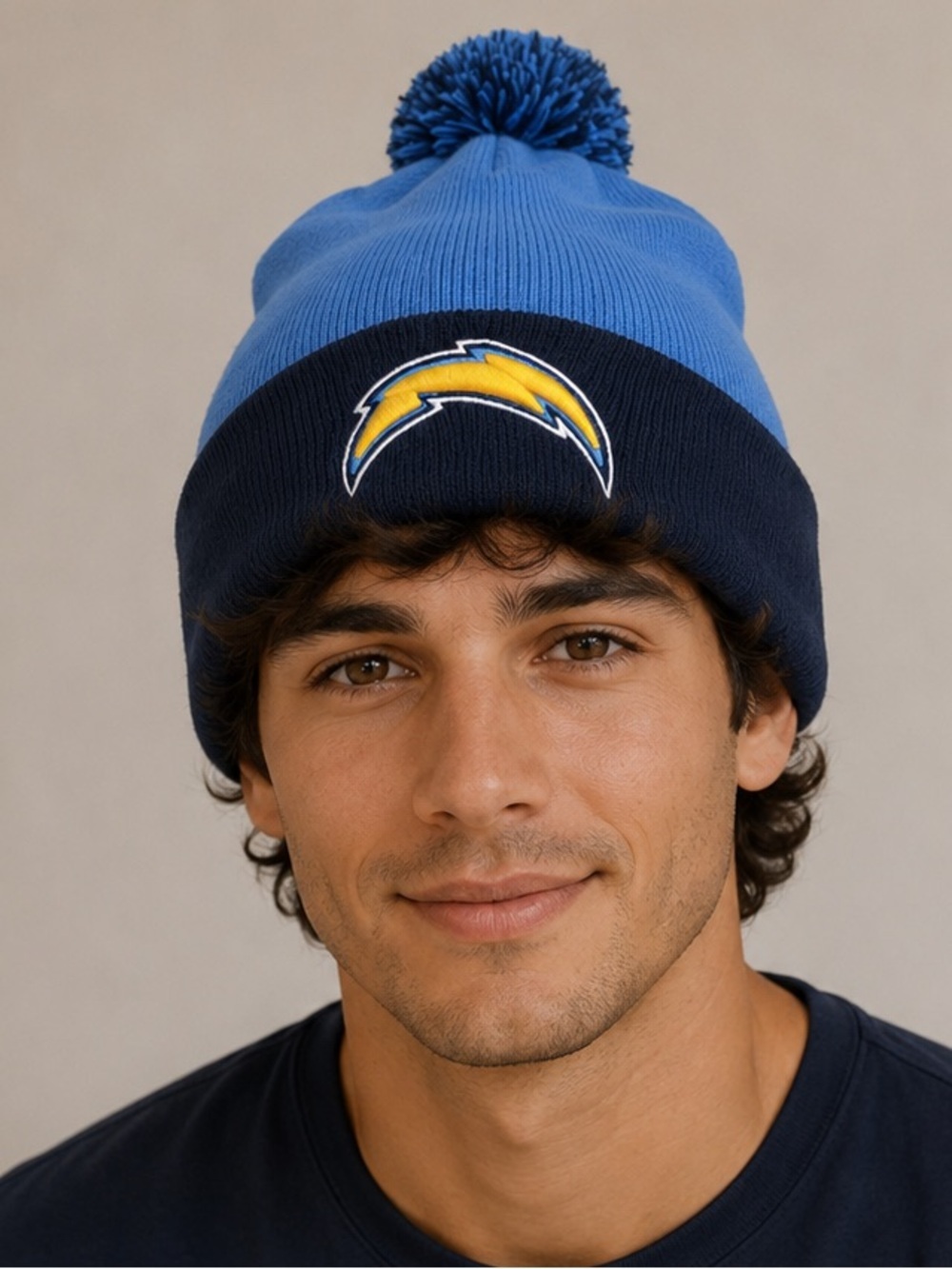 New Era Los Angeles Chargers cuffed knit beanie with a pom-pom on top.
